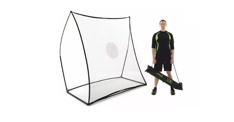 player stood beside a large football rebounder net