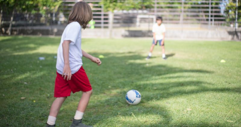 two children playing one v one football