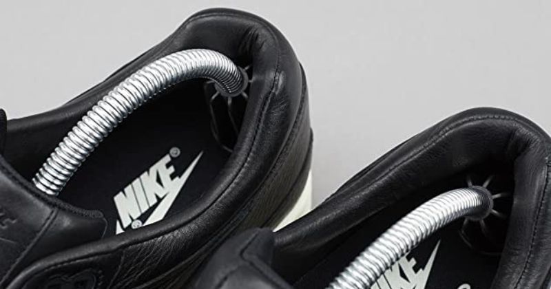 black nike boots being stretch by shoe trees