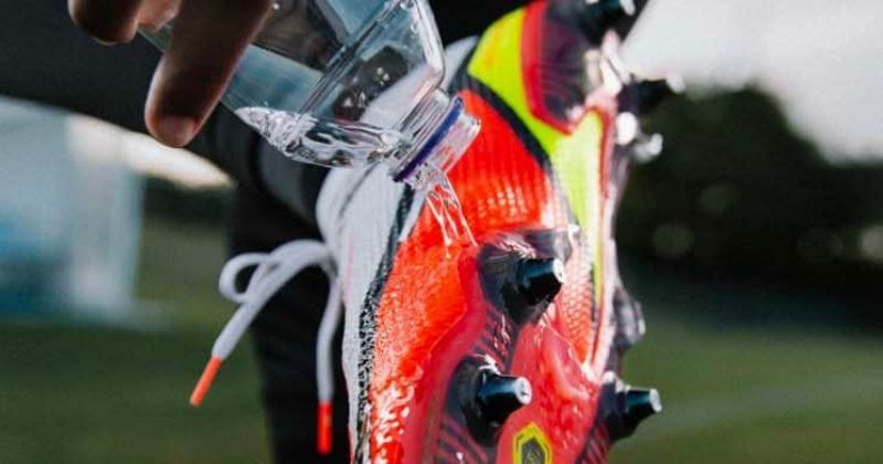 football boots being rinsed off with water