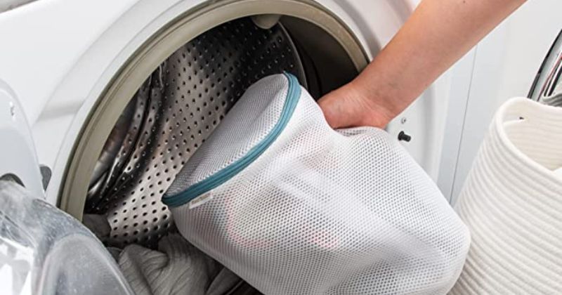 washing bag being placed in washing machine