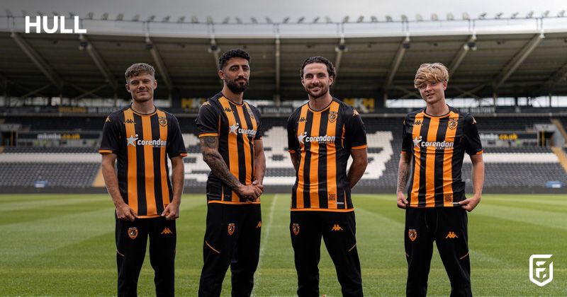players wearing hull city 2023-24 home shirt in black and orange at stadium