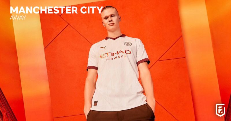erling haaland wearing manchester city 2023-24 away shirt in white and maroon